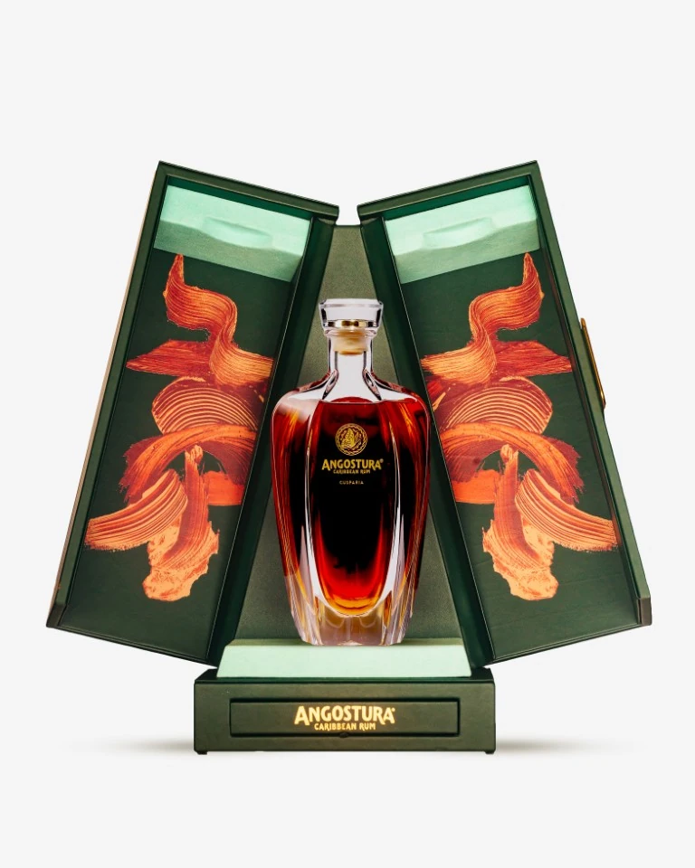 Angostura Cusparia bottle in an open presentation case, with orange and copper-coloured expressive artwork on the inner panels.