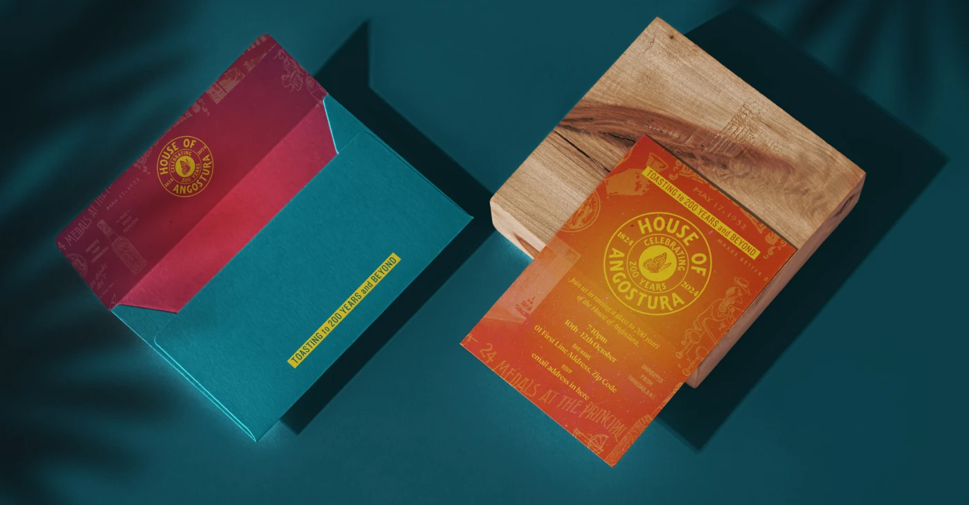 Angostura anniversary event invitations and an envelope in orange, red and teal.
