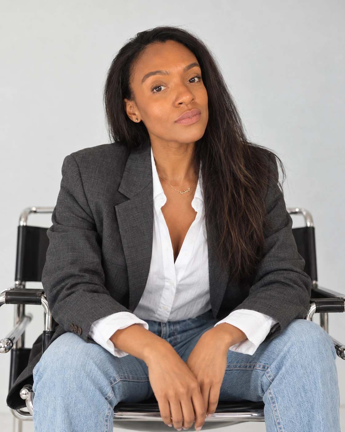 Sophie Charles-Barber seated in a studio, looking towards the camera